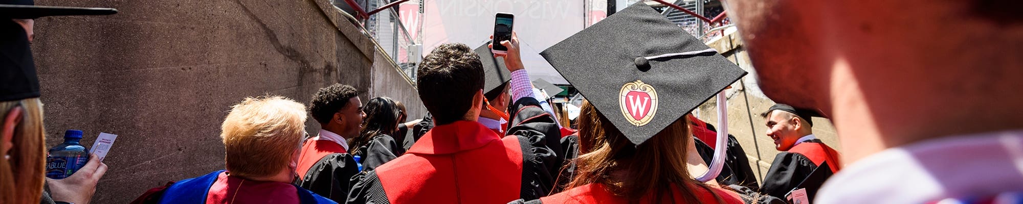 a UW-Madison graduate takes a photo on graduation day