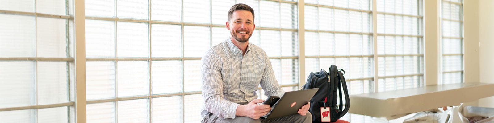 Dan Barry sitting with laptop