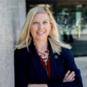 Kristy Jorgensen posing for a picture in front of a government building