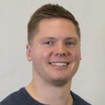 Headshot of Zach Benson, a UW–Madison Online enrollment coach, smiling 
