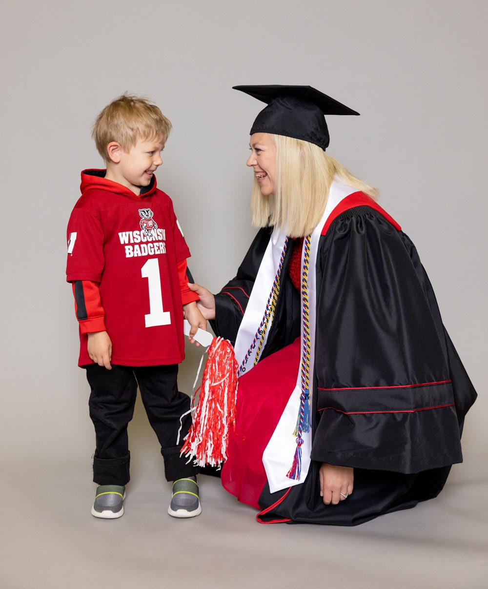 Kristy in her graduation gown with her son