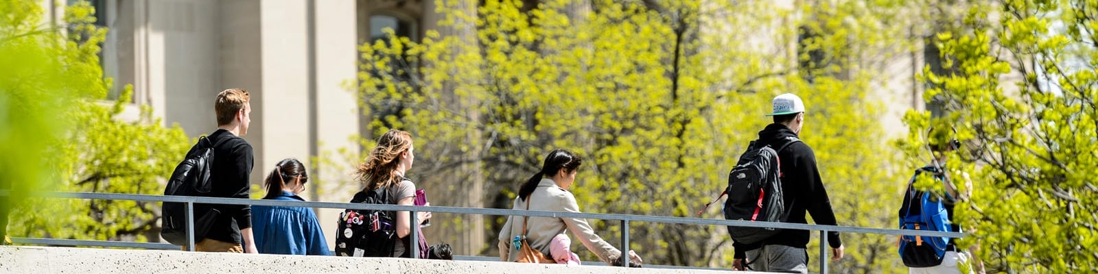 Students cross pedestrian overpass.