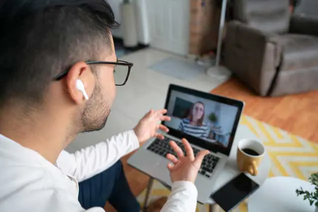 Student having a video call with their enrollment coach from home