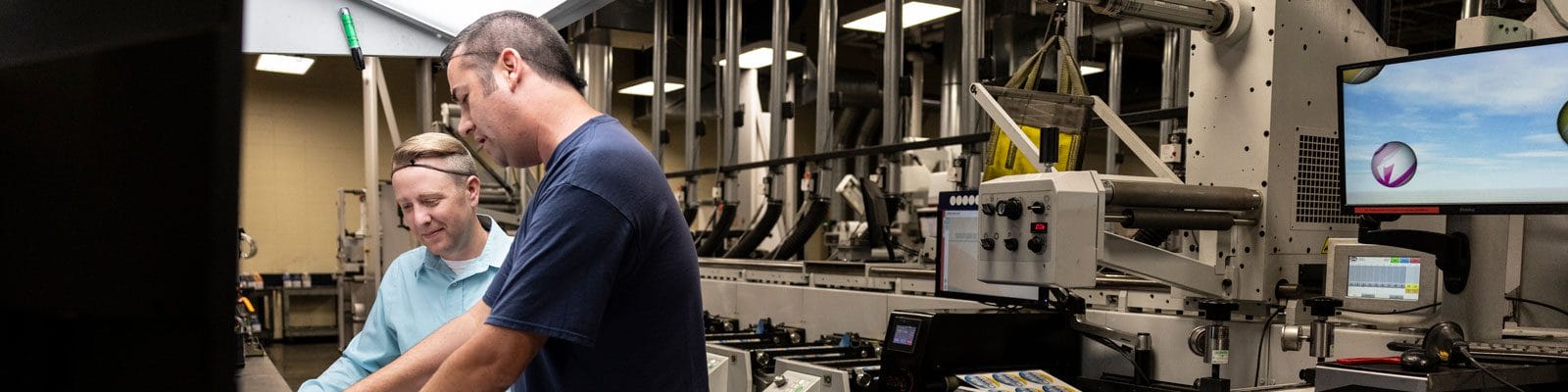 John Gloeckler observing an item in a lab