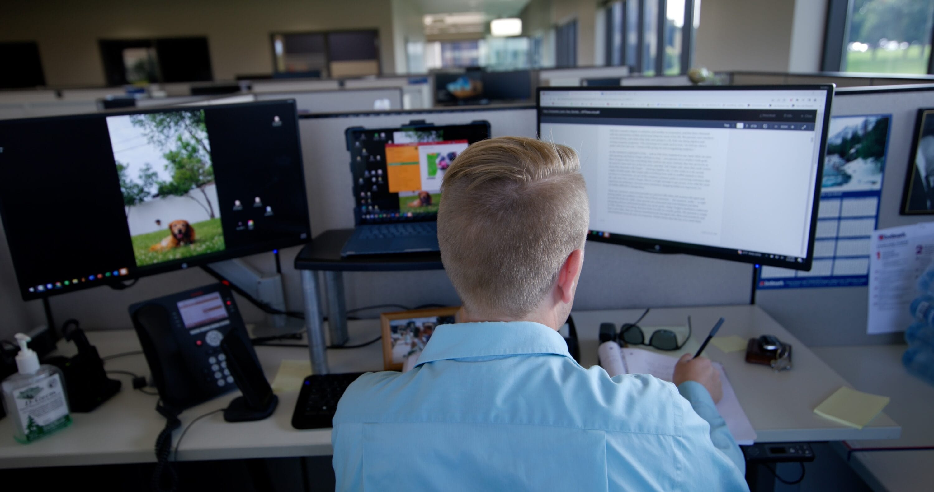 Back view of John Goeckler as he writes up a paper.