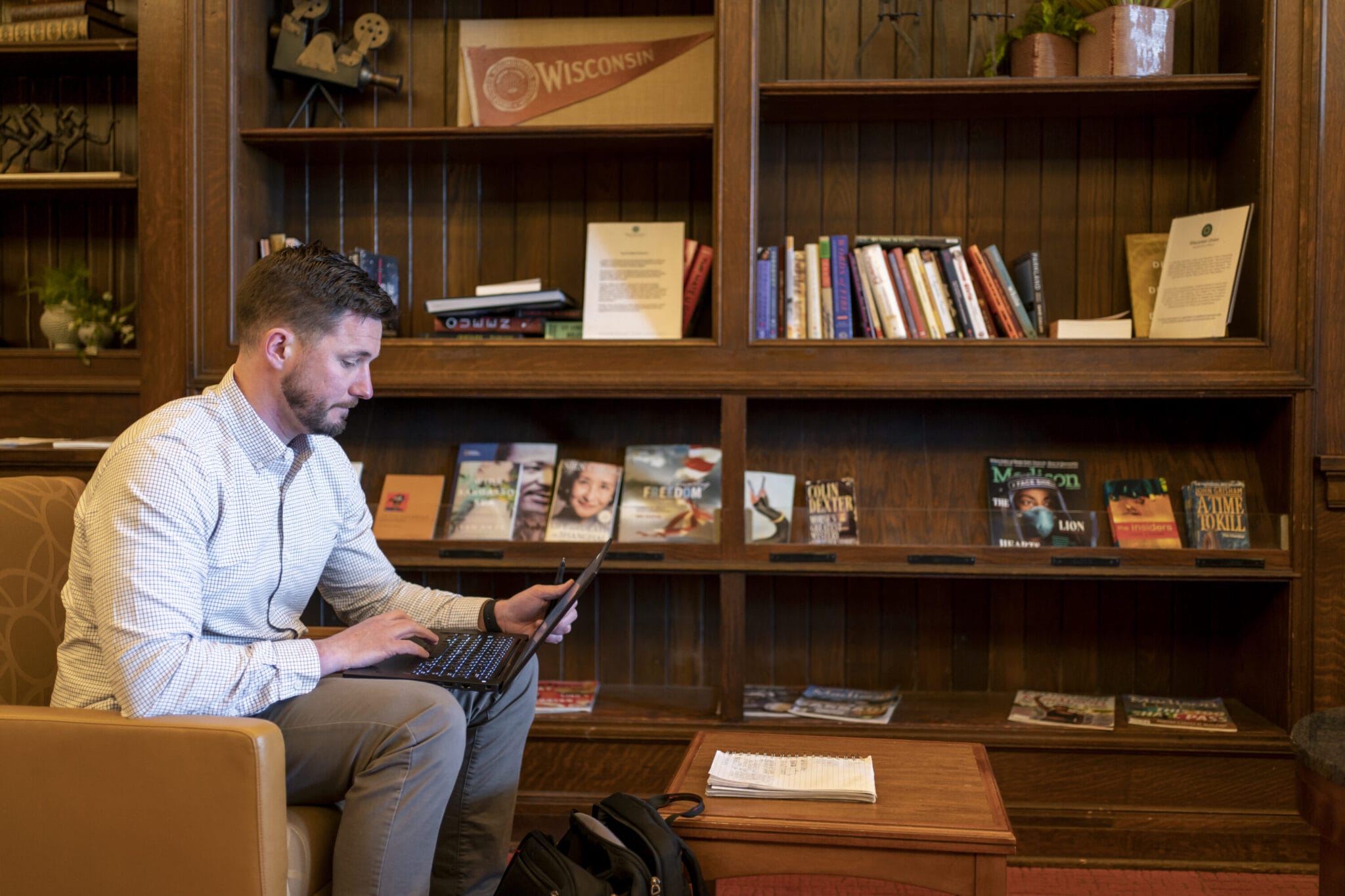 Dan Barry working on his laptop in a library.