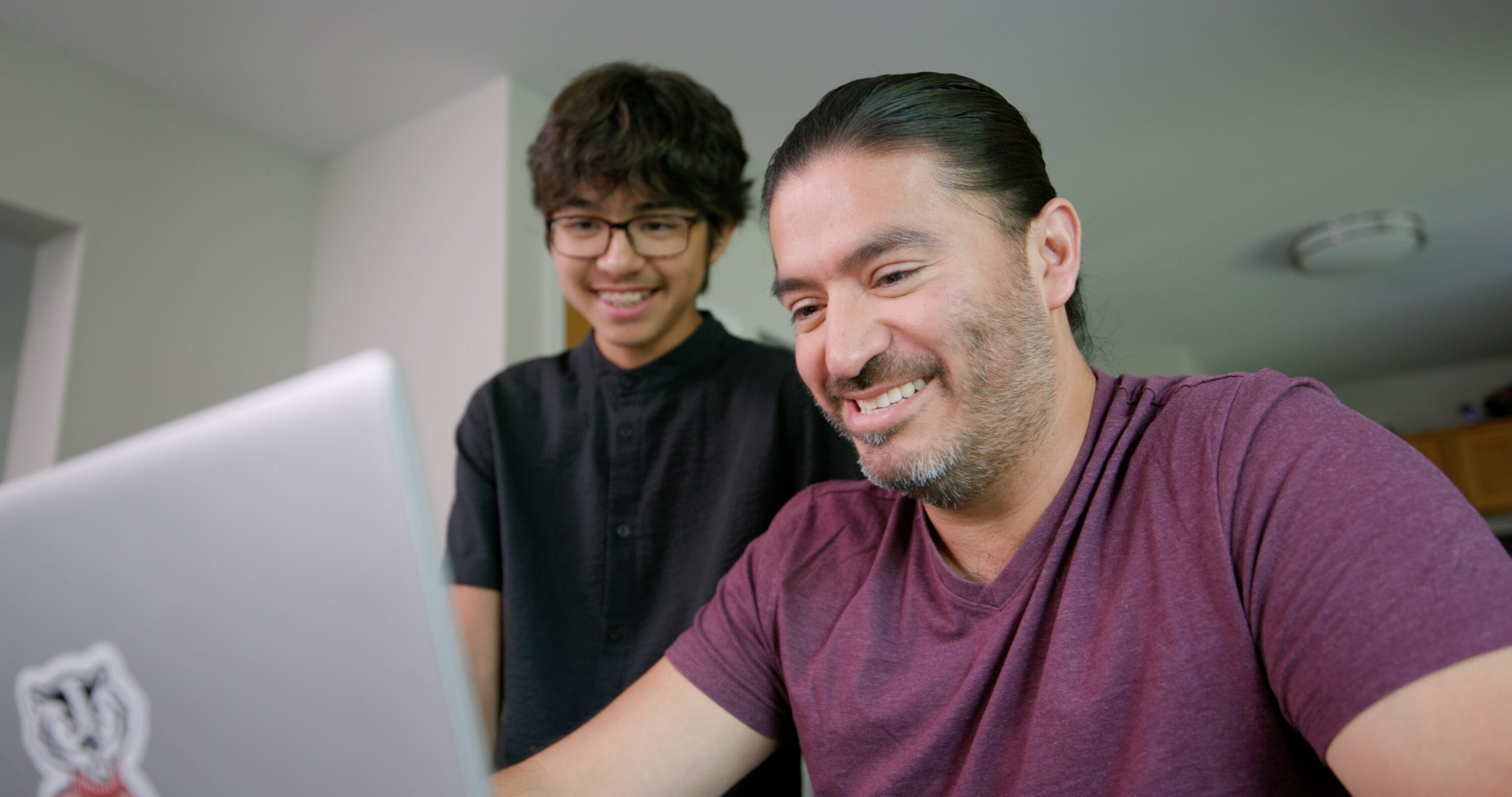 Many Avila and his son smiling together.