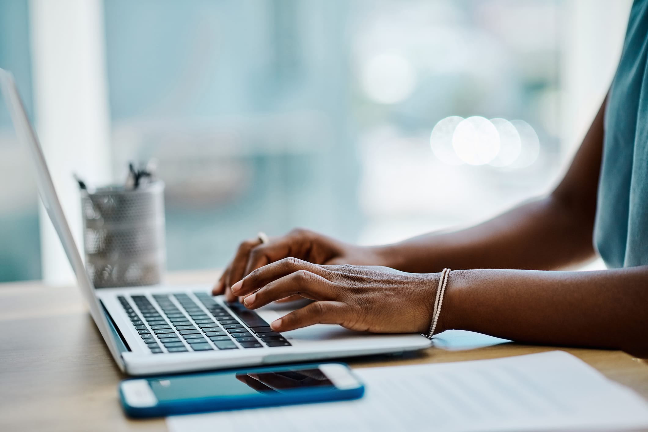 An image of a pair of hands typing on a keyboard.