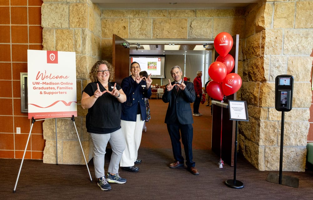 Greeters at the door making the UW 'W' hand sign