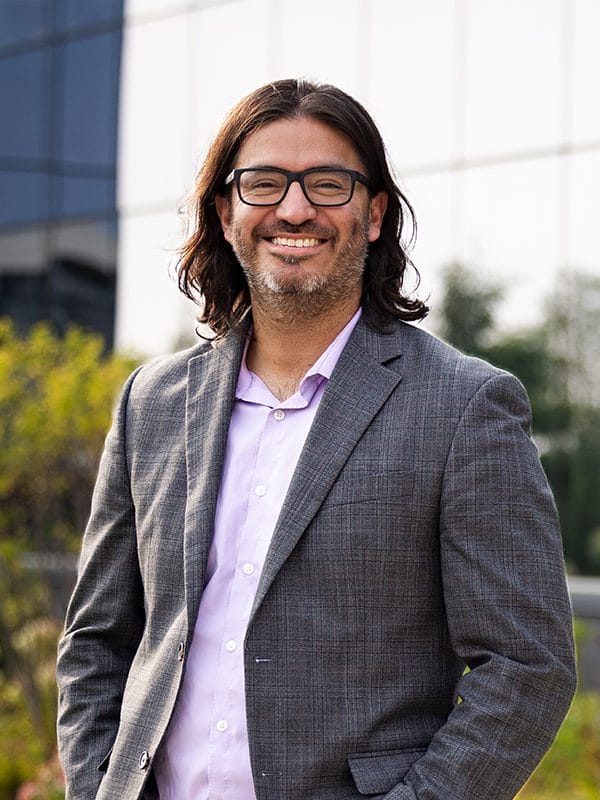 headshot of Manny Avila standing outside, smiling