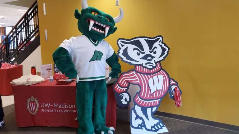 Rhinelander symbol and high school mascot the Hodag next to Bucky.